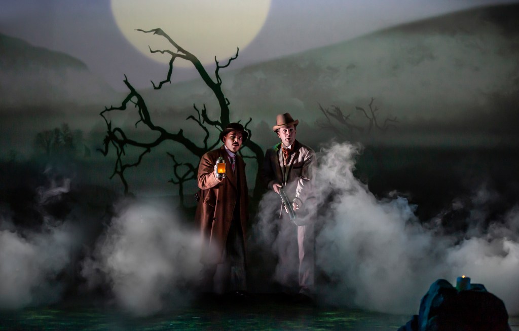 Imagine shows Holmes and Waston on the Baskerville moor at night with lanterns walking through the fog of the moors looking very alert!